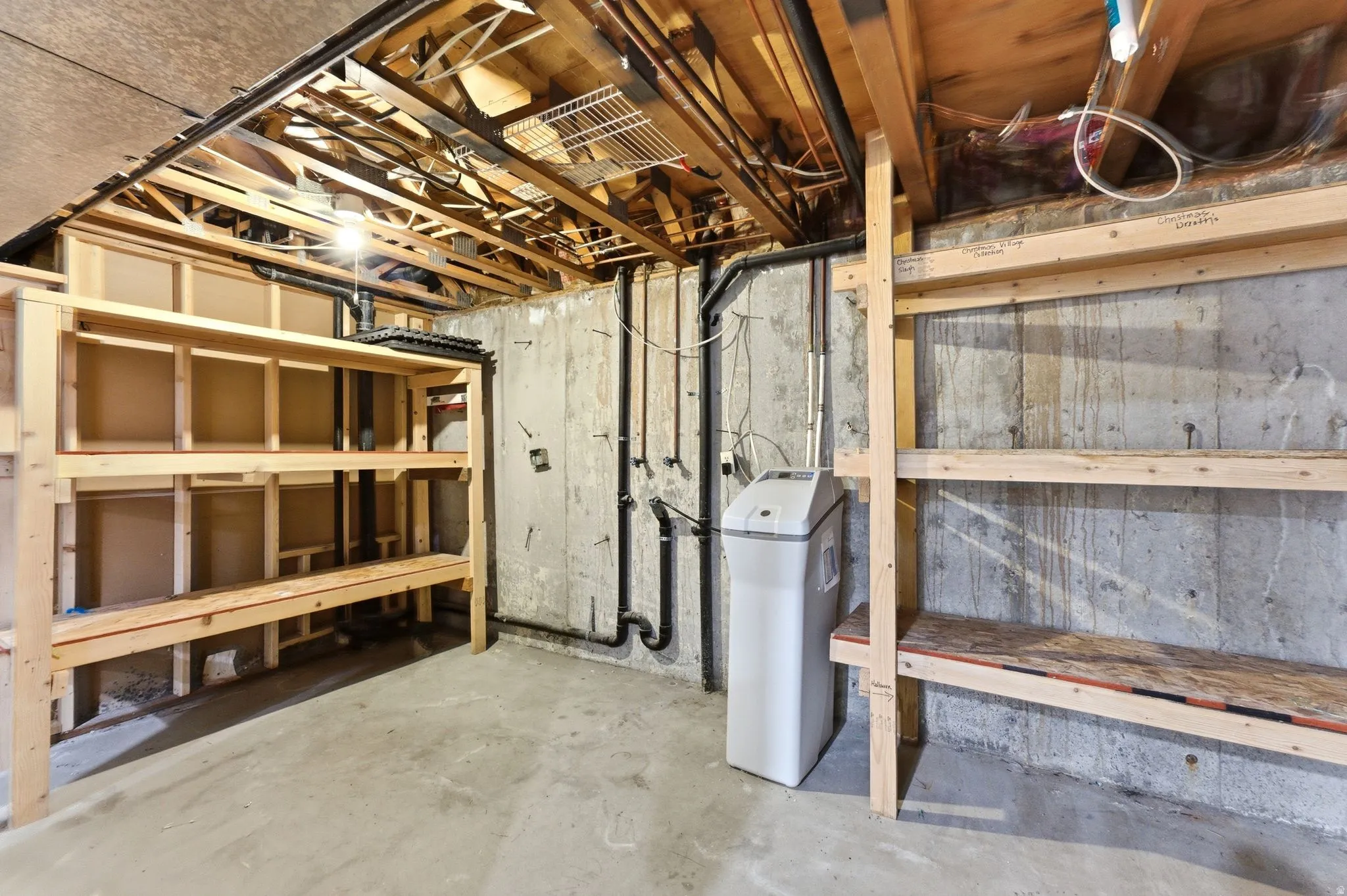 Utility space featuring built in shelves and plumbed for a 2nd laundry room.