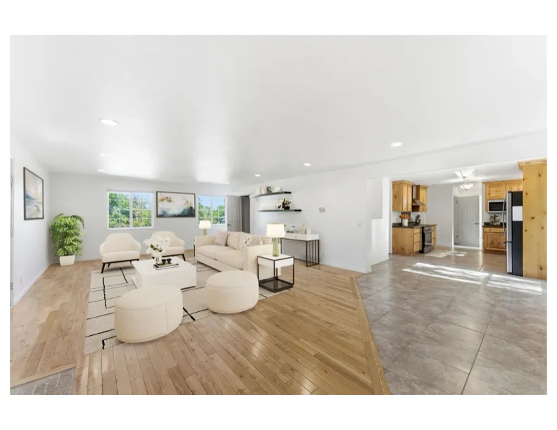 Virtual staged - Spacious open-concept living area featuring light wood-finish flooring and multiple windows