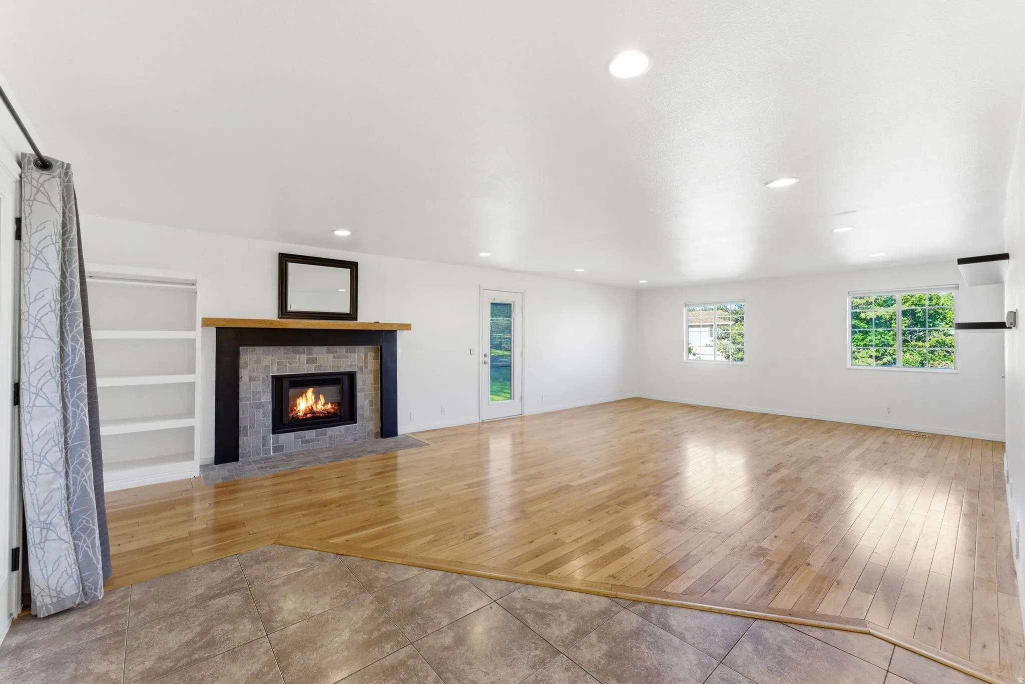 Spacious family room area featuring beautiful wood  flooring and new electric  fireplace