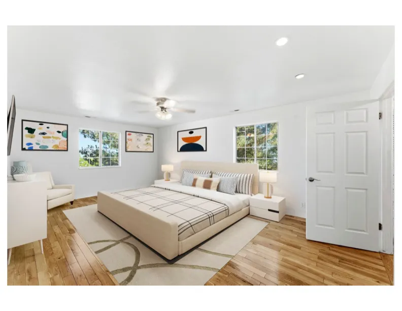 Virtual staged photo - Spacious primary suite  featuring hardwood floors.