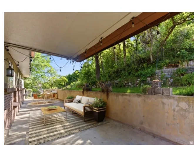 Virtual Staged photo -Covered outdoor patio with string lighting.