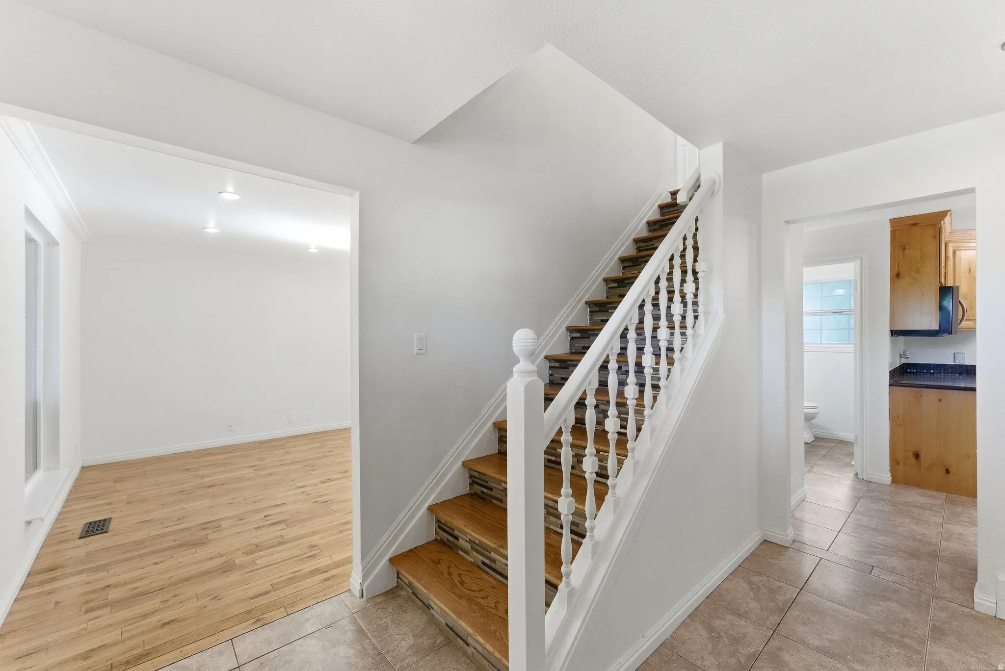 Entryway showing living room and kitchen access