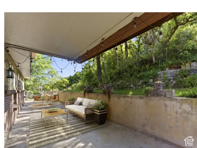 Virtual Staged photo -Covered outdoor patio with string lighting.