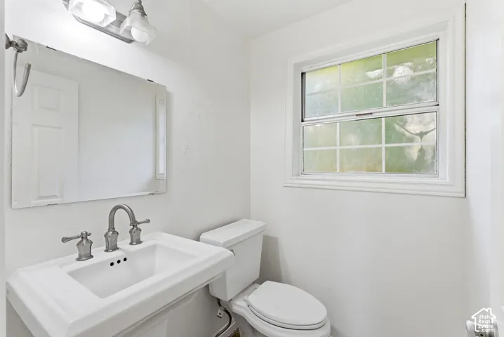 Main level 1/2 bathroom with pedestal sink.
