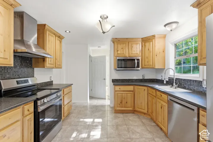 Kitchen featuring Alder cabinets, stainless steel appliances and tile floors