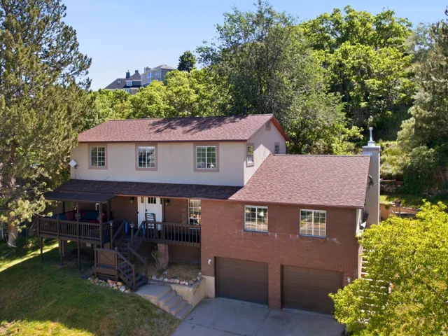 Front of home features covered deck to enjoy sunsets.
