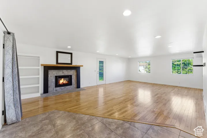Spacious family room area right off kitchen featuring beautiful wood flooring and new electric  fireplace