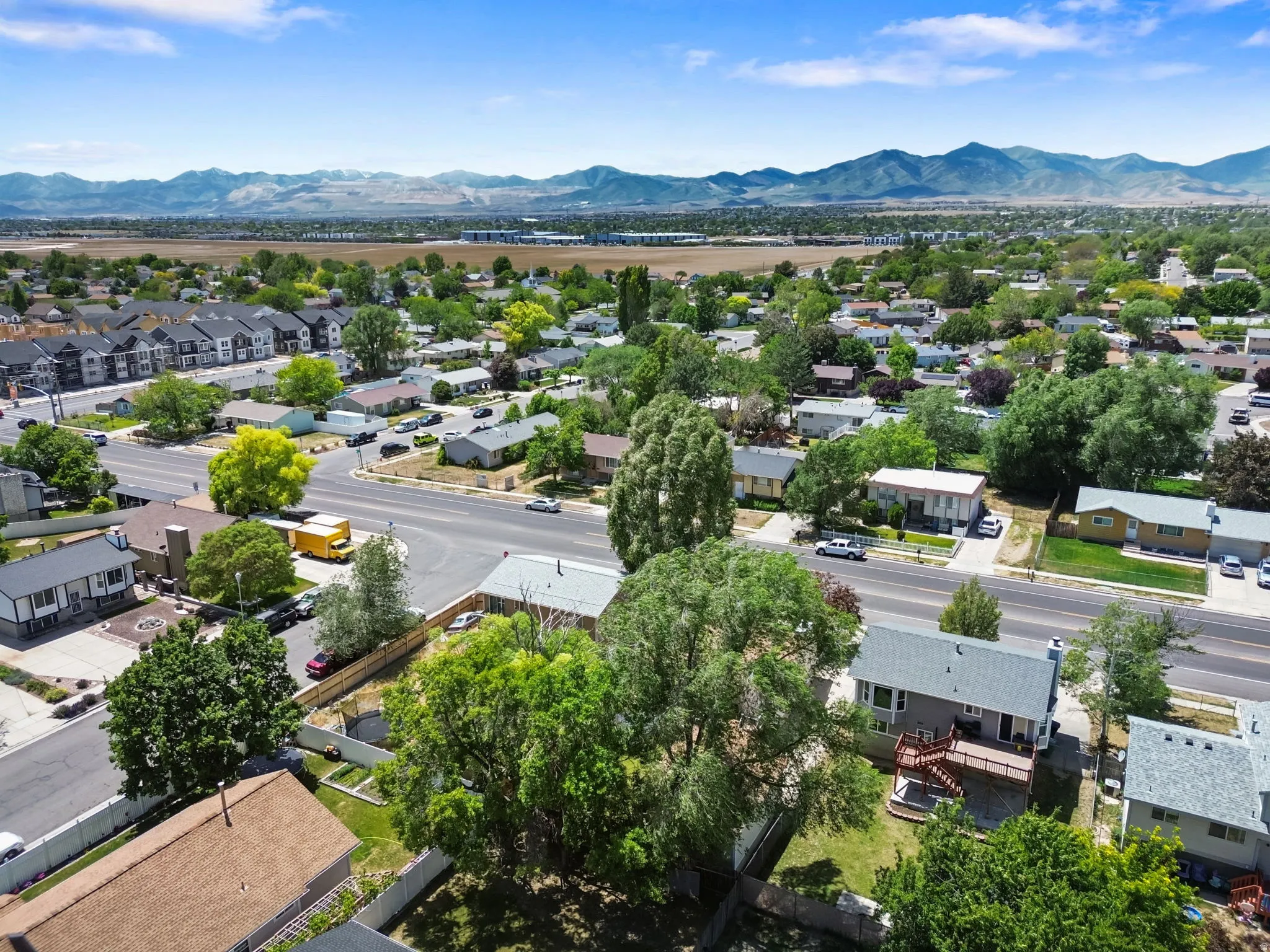 Expansive neighborhood featuring mature trees and a distant mountain range