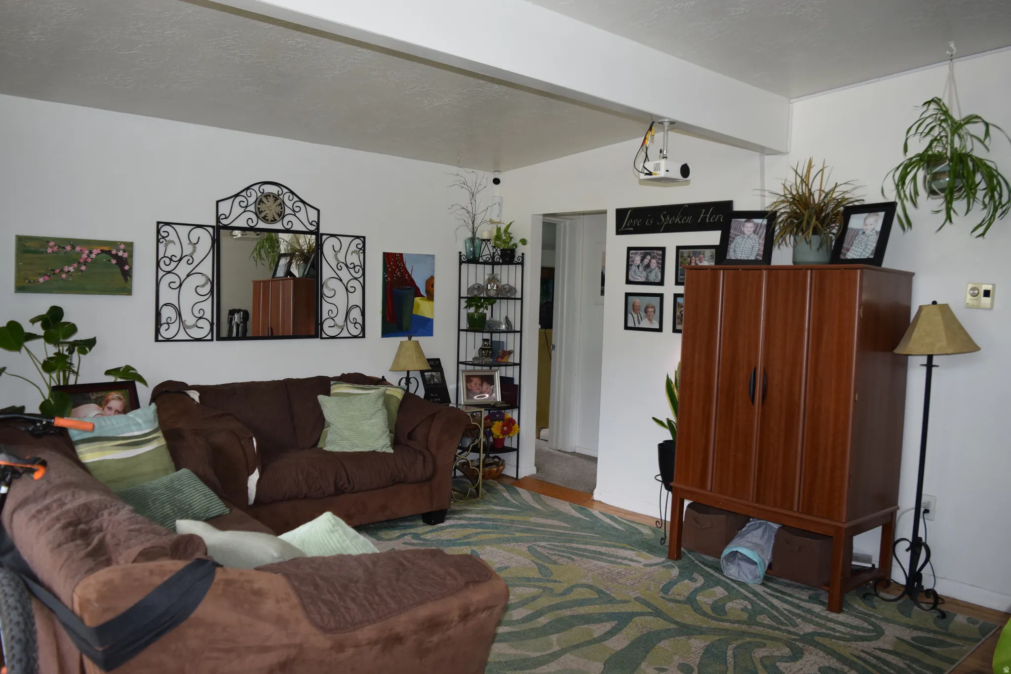 Spacious living area featuring white walls and a light-colored ceiling