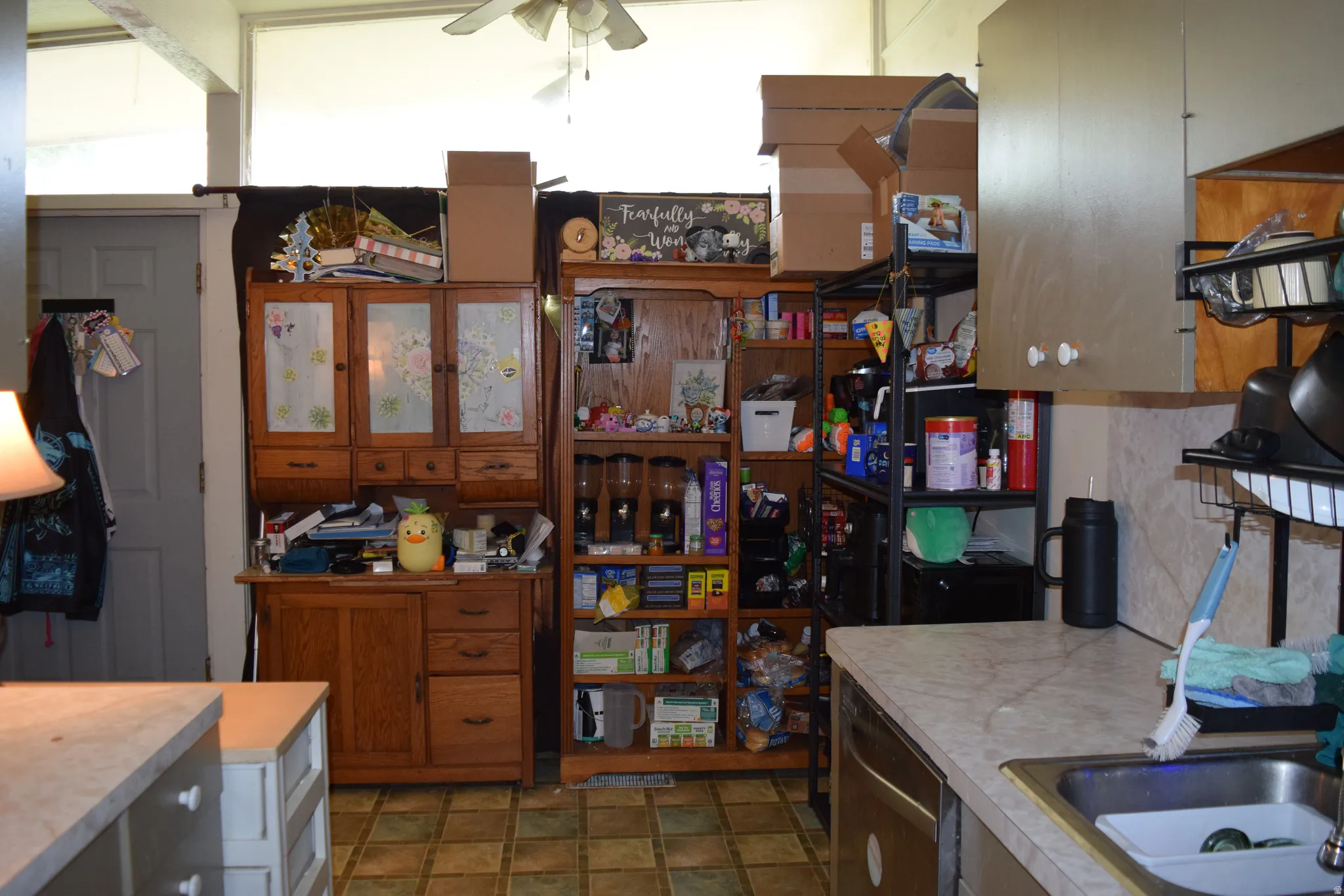 Kitchen area featuring a built-in stainless steel sink, laminate countertops, and vinyl tile flooring