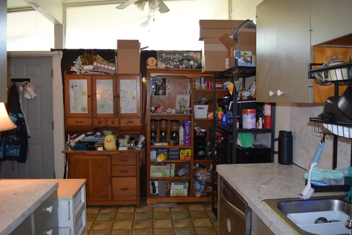 Kitchen area featuring a built-in stainless steel sink, laminate countertops, and vinyl tile flooring