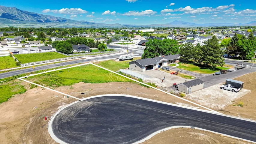 Expansive level lot with established green space, featuring a newly paved cul-de-sac and mountains in the distance