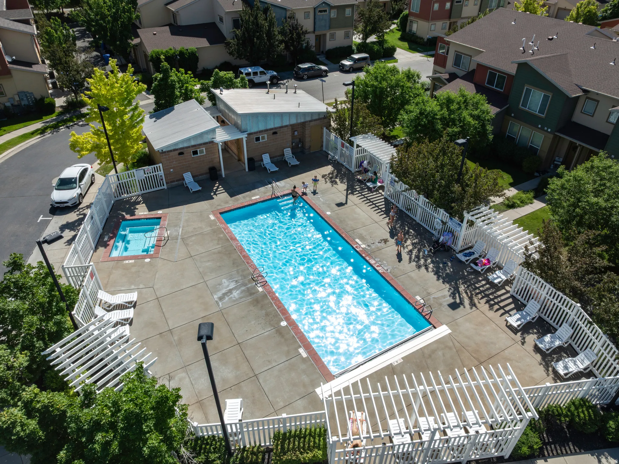Outdoor swimming pool and spa area with surrounding concrete decking