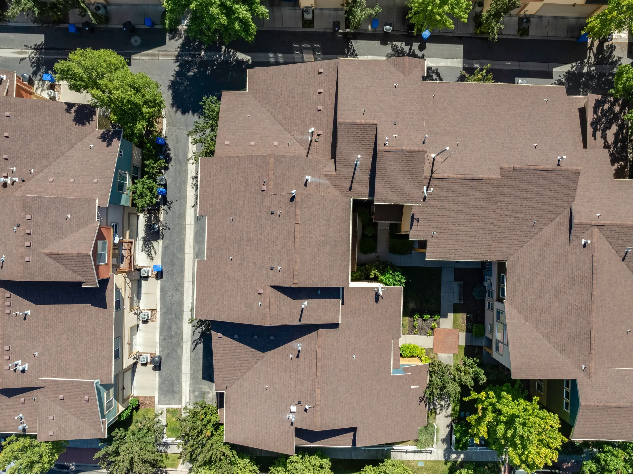 Multi-unit property featuring complex rooflines and a central courtyard