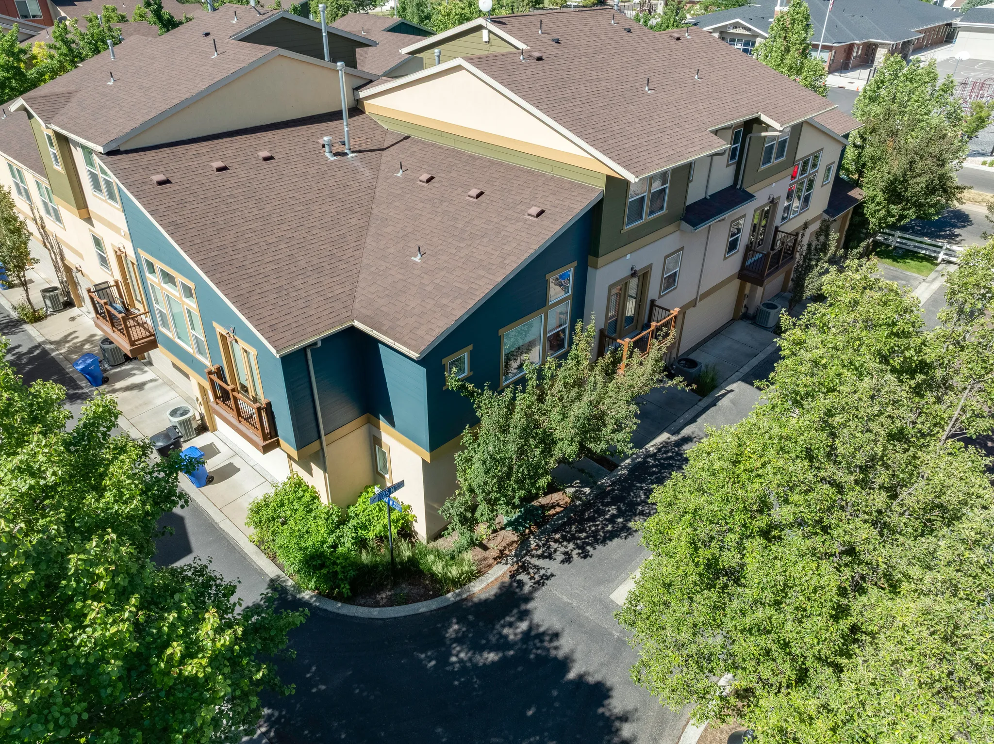 Multi-level residential structures featuring varied exterior siding, gabled roofs, and multiple balconies