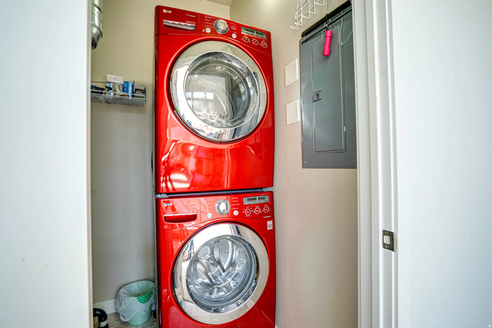 Dedicated laundry closet featuring a stackable washer and dryer unit