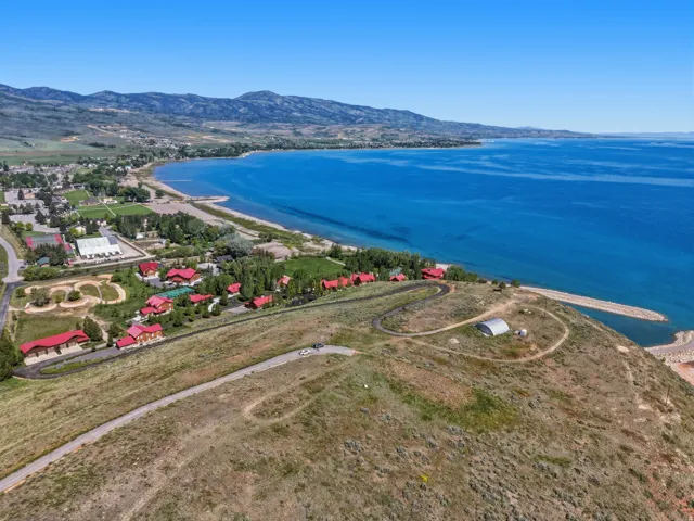 Expansive property offering extensive lake frontage, a private boat launch, and multiple structures with red roofs