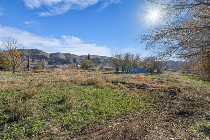 Expansive natural terrain featuring varied vegetation and a mountainous backdrop