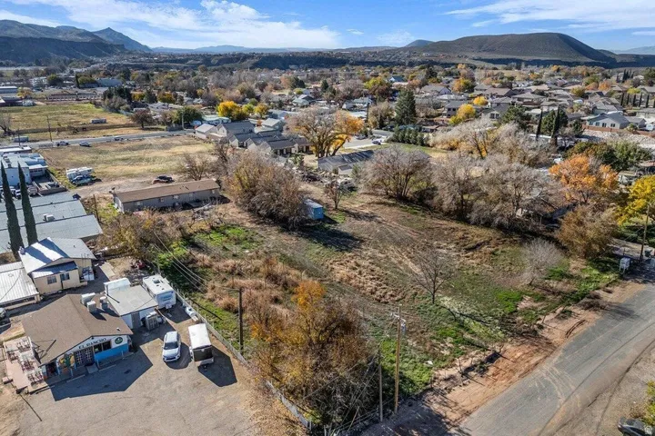 Expansive undeveloped land featuring natural ground cover and scattered deciduous trees