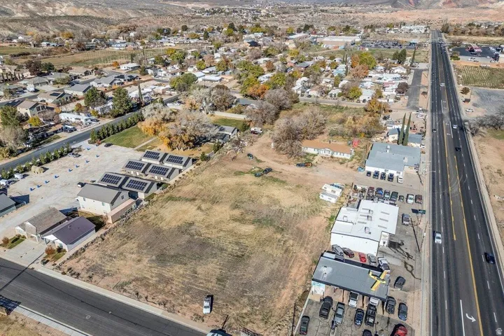 Expansive property featuring multiple buildings, solar panel installations, and direct road frontage