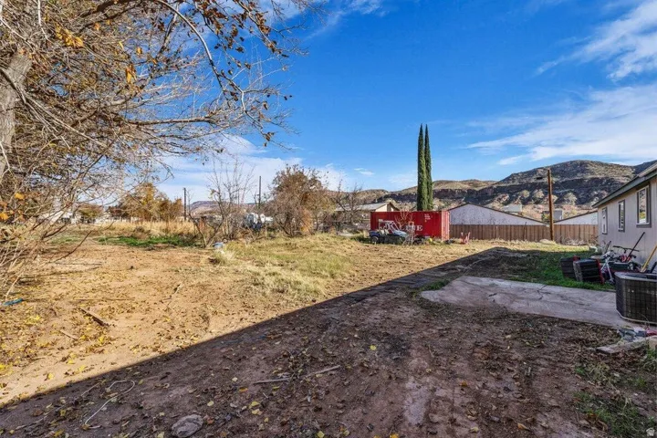 Expansive land parcel featuring existing concrete paving and a partial grassy area