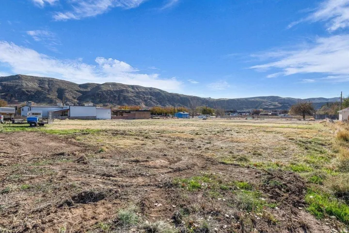 Expansive land parcel featuring clear skies and distant mountain ranges