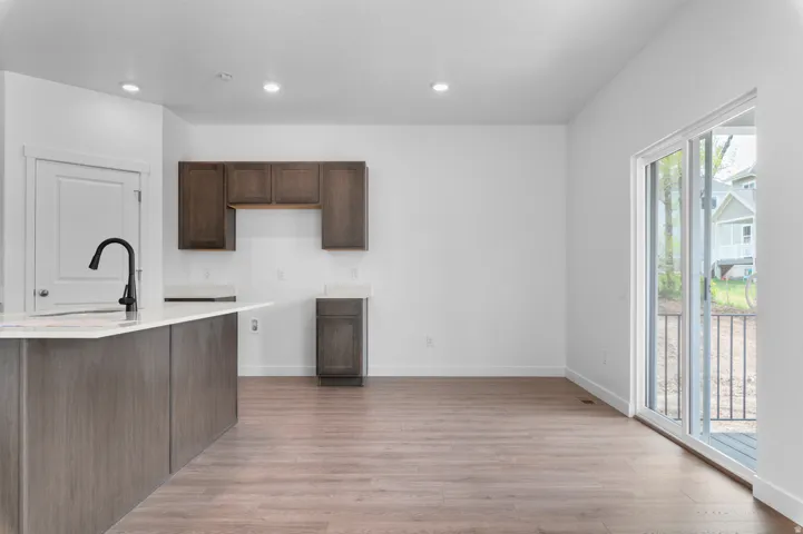 Open-concept living space with wood-finish flooring