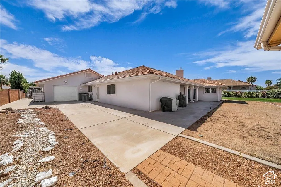 Exterior featuring a stucco finish, a tile roof, a two-car garage, and a concrete driveway