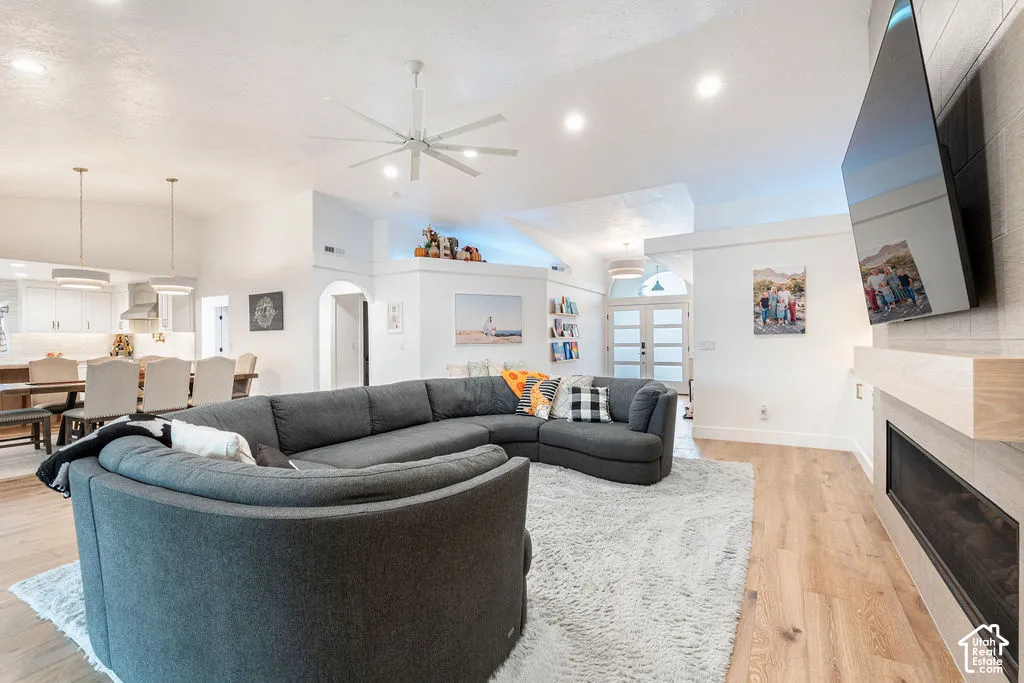 Vaulted ceilings and wood-finish flooring complement the integrated fireplace with a light wood mantel