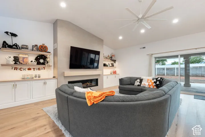 Vaulted ceiling with a large ceiling fan and recessed lighting