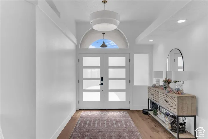 Entryway featuring double glass-paneled doors, an arched transom, and recessed lighting