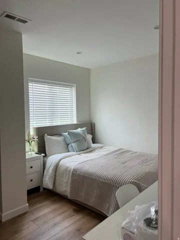 Room featuring wood-finish flooring, recessed lighting, and a window with blinds
