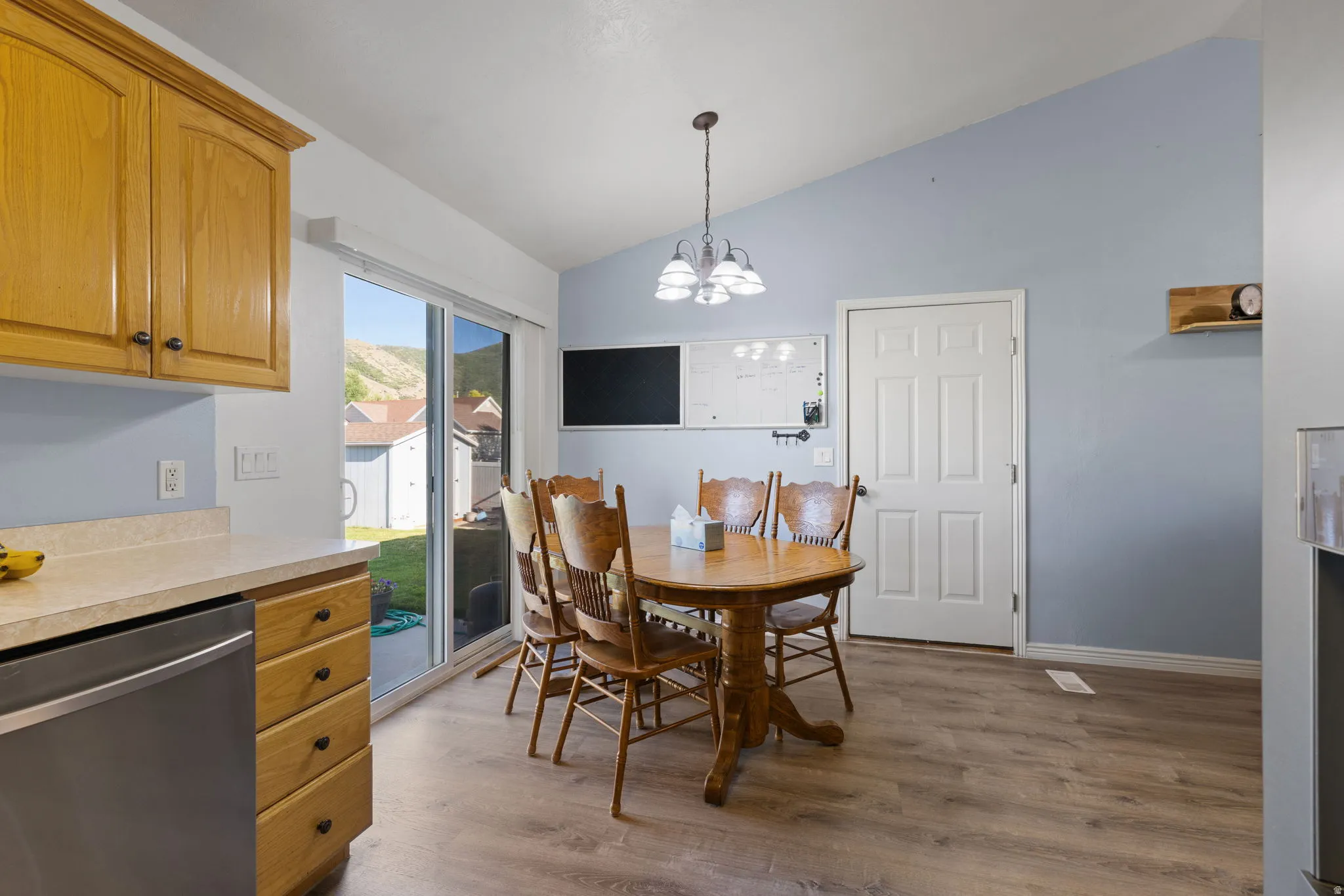 Combined kitchen and dining area featuring wood-finish flooring