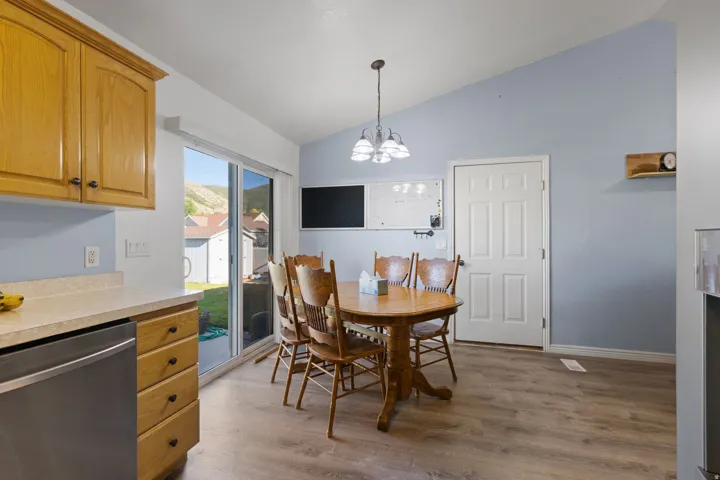 Combined kitchen and dining area featuring wood-finish flooring