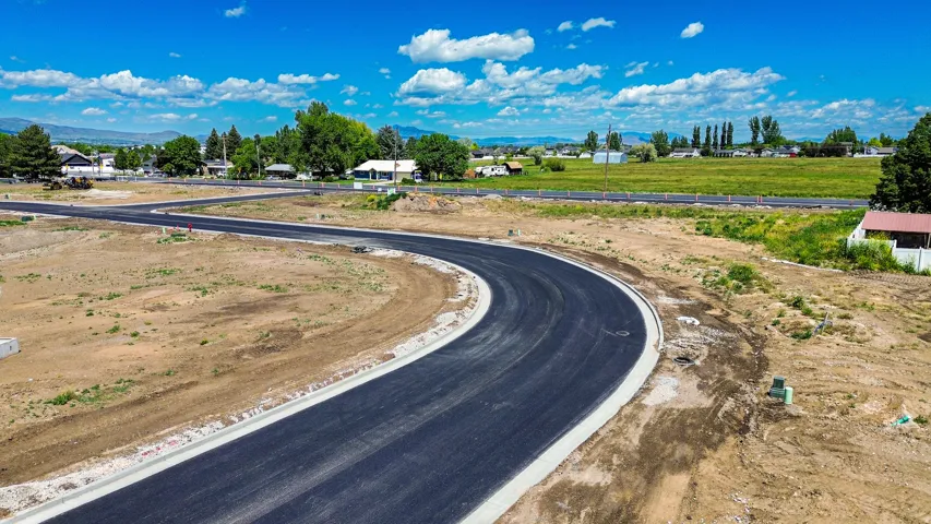 Newly paved asphalt road with concrete curbing