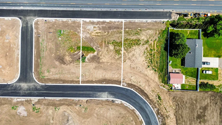 Newly developed residential lots featuring paved road access, designated property lines, and utilities infrastructure