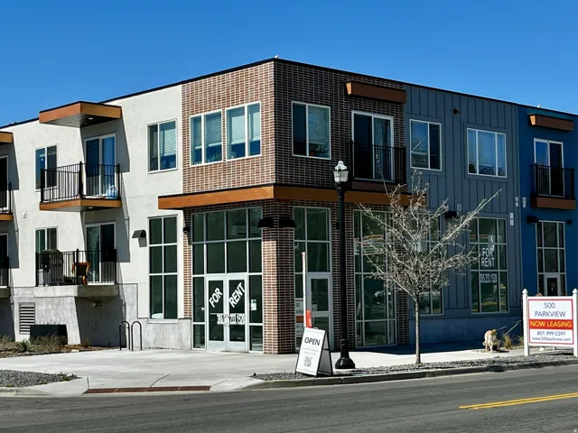 Contemporary multi-story building featuring varied facade materials including brick, stucco, and vertical siding