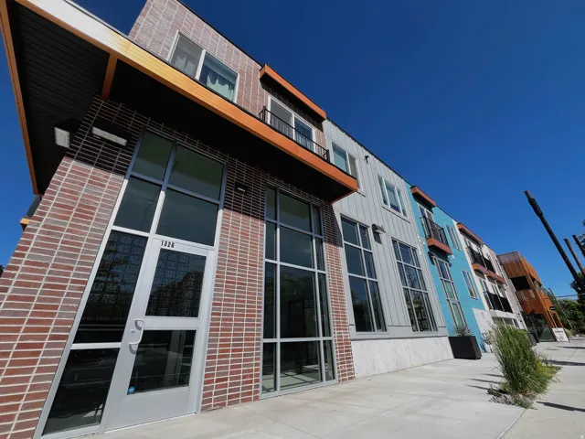 Modern facade featuring a combination of brick, horizontal siding, and large pane windows
