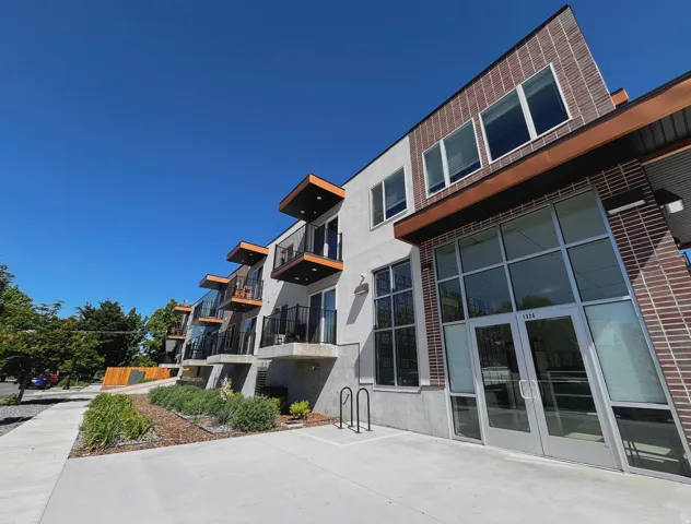 Modern multi-story building featuring a brick facade and stucco finishes
