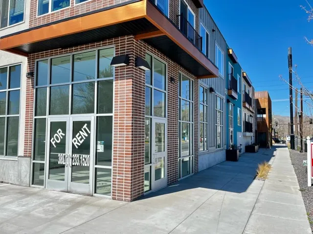Modern commercial storefront featuring expansive glass windows and double entry doors