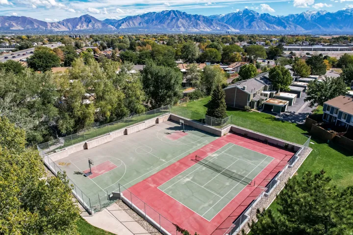 Outdoor recreation area featuring a full basketball court and a tennis court