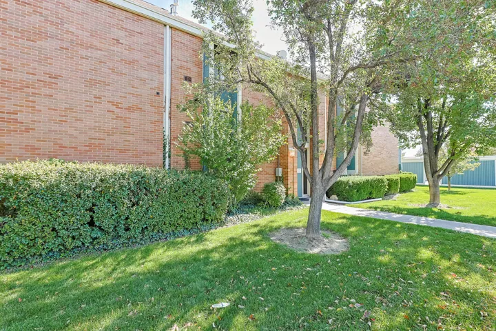 Brick exterior featuring mature landscaping