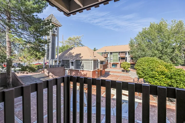 Balcony overlooking a central courtyard with a brick paver surface