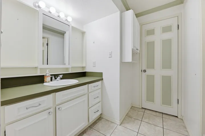 Vanity with integrated sink and green countertop