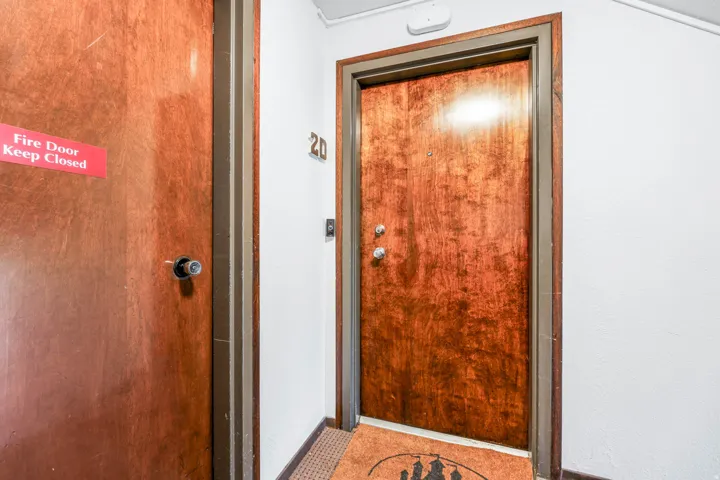 Rich wood-finish entry door with modern hardware