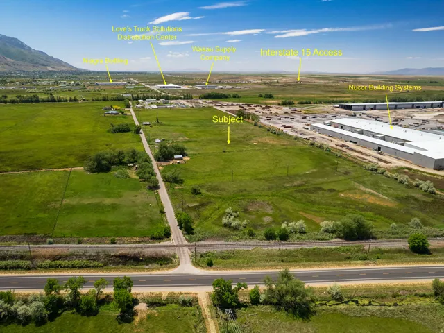 Expansive land parcel featuring open fields and direct road frontage