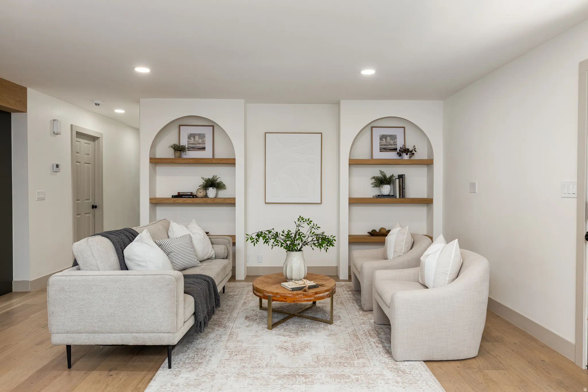 Living space featuring recessed lighting and wood-finish flooring