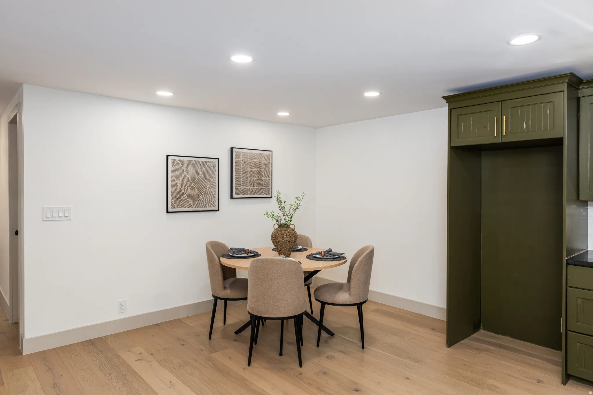Contemporary dining area featuring recessed lighting, light wood-finish flooring, and white baseboards