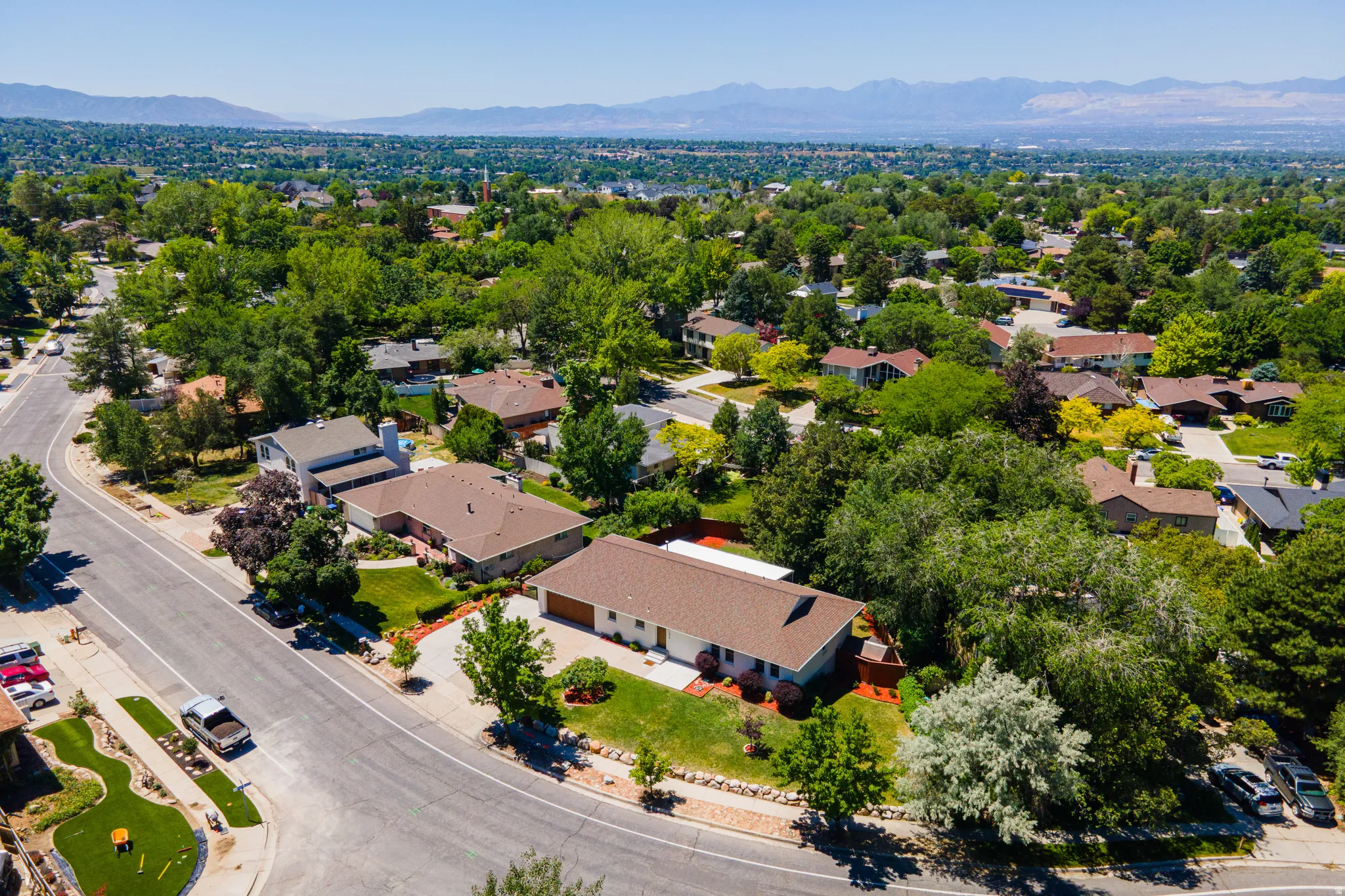 Expansive residential neighborhood featuring mature trees and mountain scenery