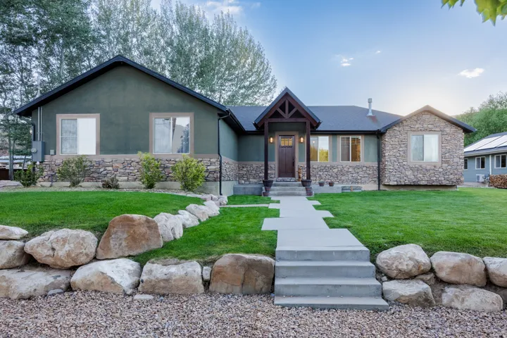 Modern ranch-style home featuring a stone and stucco exterior